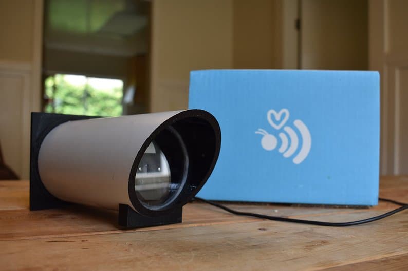 Eyesonhives bee monitor with Eyesonhives logo on a wooden table